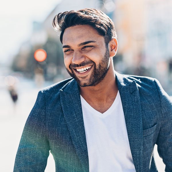 man in suit jacket smiling