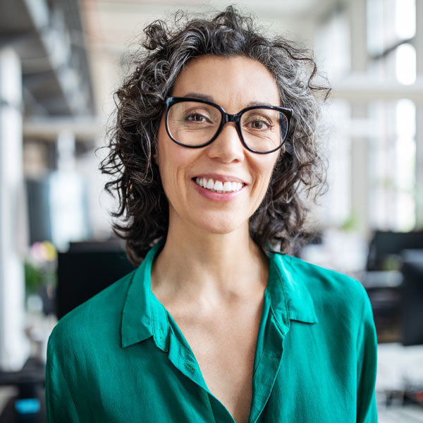 woman with glasses smiling